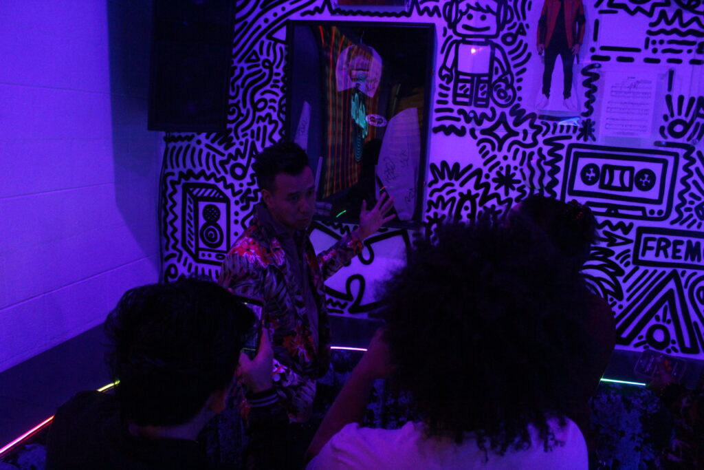 DJs and guests inside Audio Bar under purple venue lighting